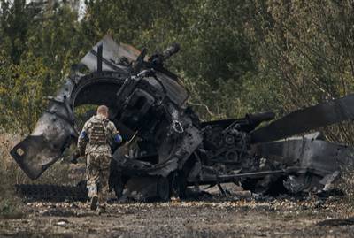 The charred remains of a Russian tank in territory retaken by Ukraine in the Kharkiv region. AP