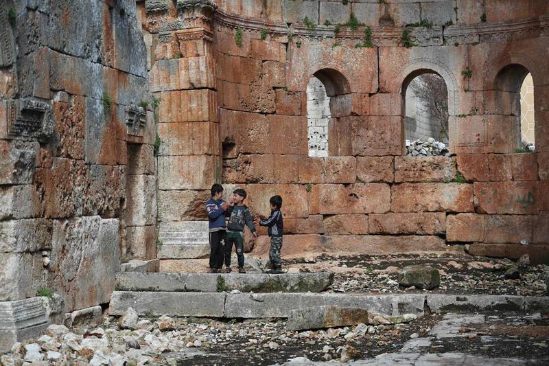 Syrian children run in the central space of the ancient Byzantine-era basilica. AFP