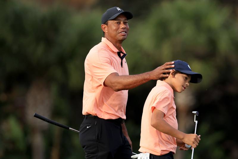 Tiger Woods and Charlie celebrate a birdie on the 15th hole. AFP