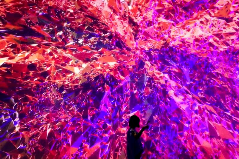 A woman takes selfie with an audio-visual art installation titled cornerstone displayed at The Future of Today Exhibition at Today Art Museum. Andy Wong / AP photo