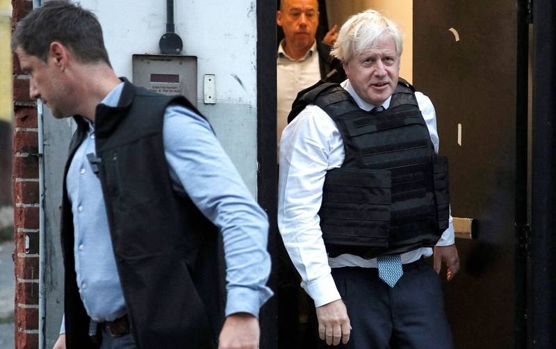Britain's Prime Minister Boris Johnson reacts as he leaves a property following a drugs related raid by Metropolitan Police officers, in London, on August 31, 2022, as part of a visit to a police station.  (Photo by PETER NICHOLLS  /  POOL  /  AFP)
