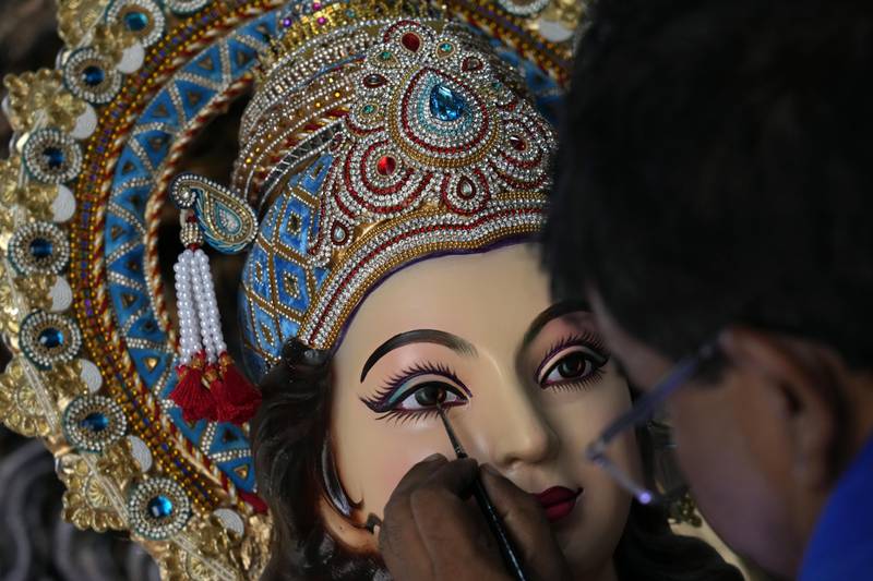 An artist works on an idol of Durga in Mumbai. AP