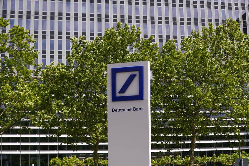 A Deutsche Bank AG logo sits on display outside the bank's offices in Eschborn, Germany, on Monday, May 25, 2020. The trickle of workers returning to Deutsche Bank’s Frankfurt headquarters are finding a new reality of takeout lunches and coffee as the lender restricts social contact. Photographer: Alex Kraus/Bloomberg
