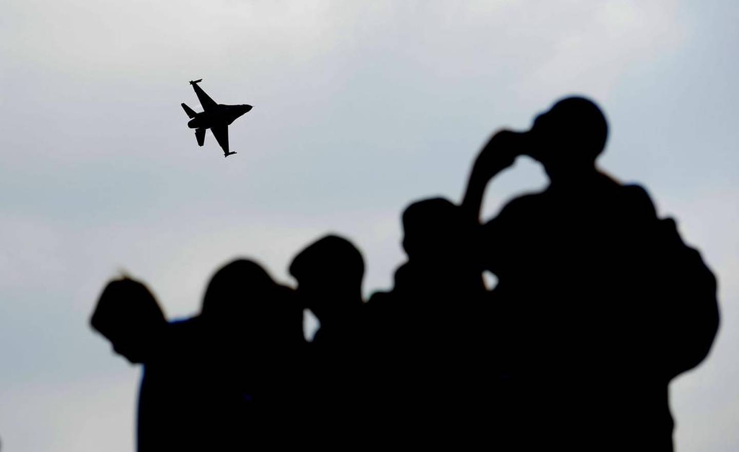 Spectators watch a MiG-29 jet fighter aircraft carrying out a demonstration during Nato Days in Ostrava, Czech Republic. EPA