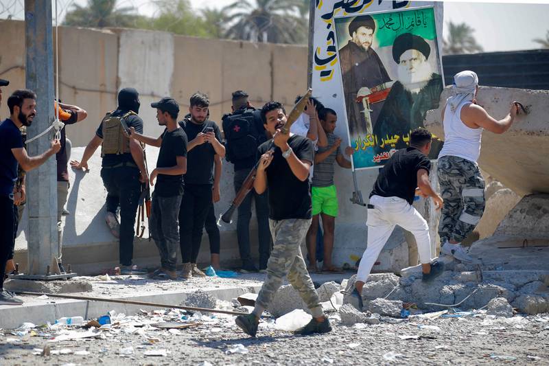 Peace Brigades members carry weapons in the fortified zone. AFP