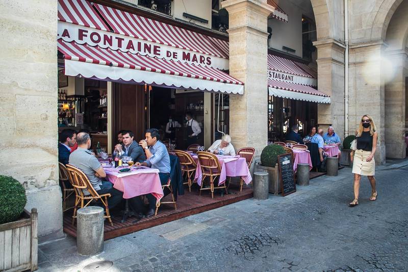 People relax on the terrace of the 'La Fontaine de Mars' restaurant in Paris. EPA