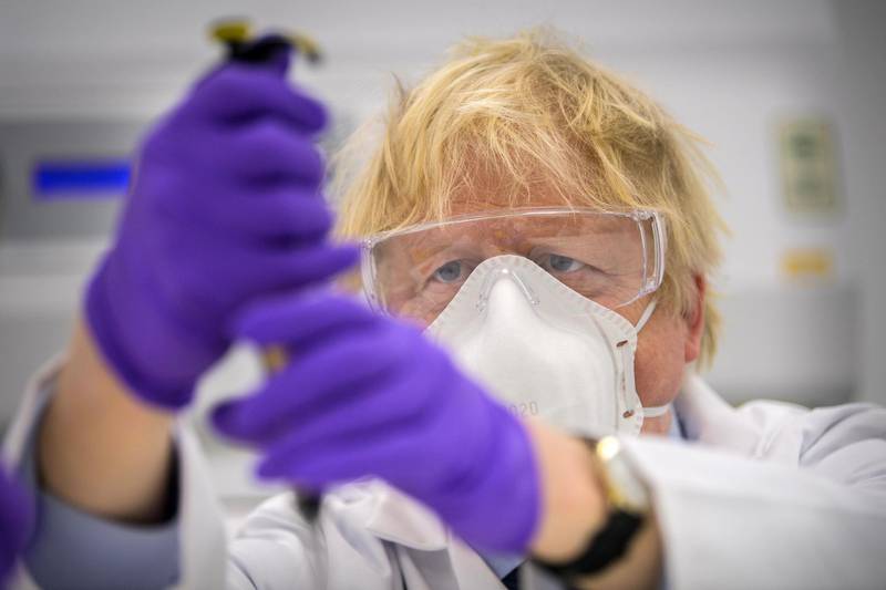 Boris Johnson tries his hand at one of the tests with Kerri Symington, quality control technician (not pictured) as he visits the French biotechnology laboratory Valneva in Livingston where they will be producing a Covid 19 vaccine on a large scale in Livingston, Edinburgh, United Kingdom.  Getty Images