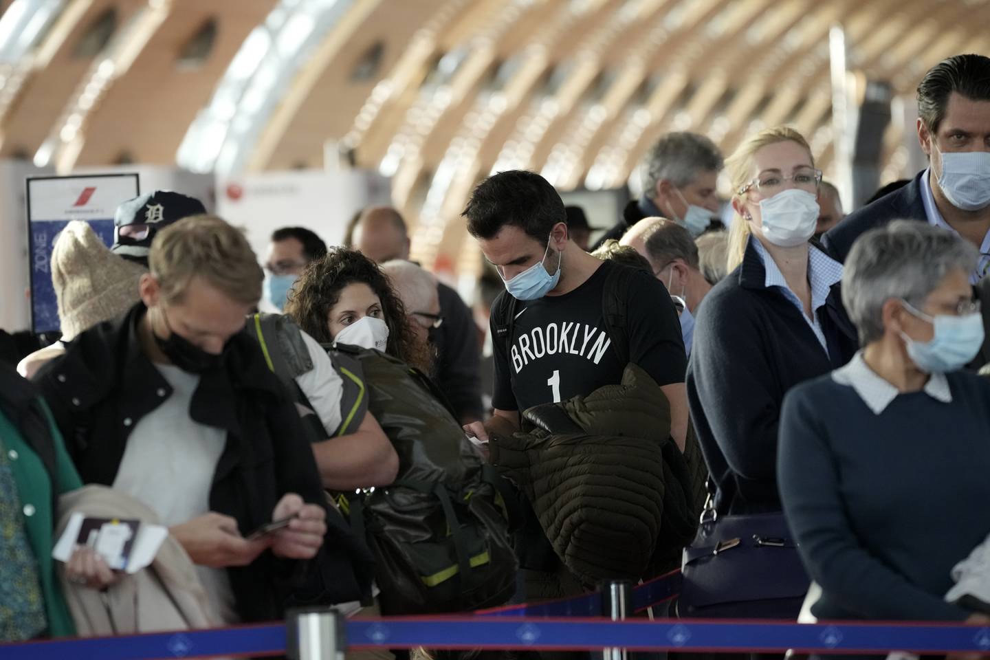 Passengers wait to board a plane at Charles de Gaulle Airport in Paris. AP 