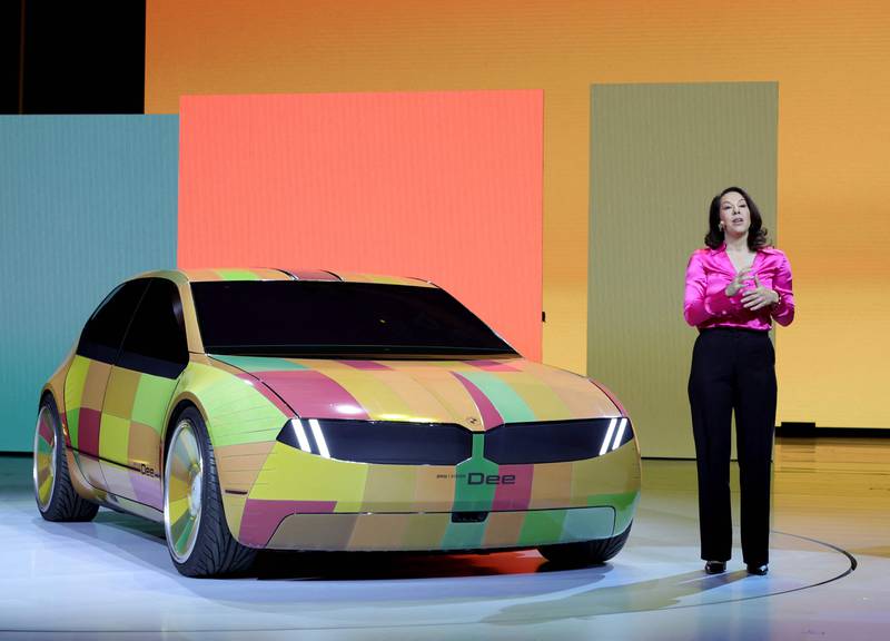 BMW project manager Stella Clarke with the colour-changing BMW i Vision Dee concept EV at the event. AFP