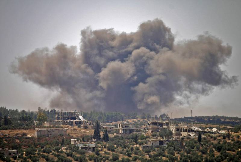 Smoke rises above opposition held areas of Daraa during airstrikes by Syrian regime forces on June 28, 2018. Syrian government forces have been ramping up their bombardment of rebel-held areas of the south since June 19, and allied Russian warplanes carried out their first raids on the region in a year on June 23. / AFP / Mohamad ABAZEED
