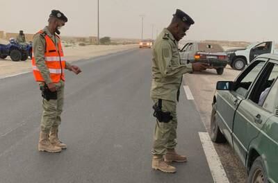 Officials check vehicles for evidence of human trafficking as they cross from Mauritania to Senegal.