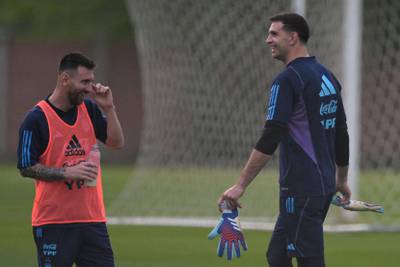 Argentina forward Lionel Messi shares a joke with goalkeeper Emiliano Martinez. AFP