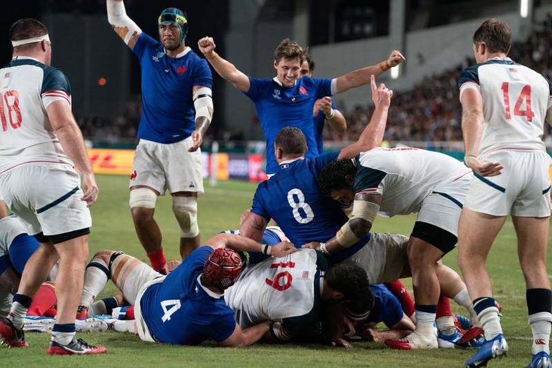 Jefferson Poirot (obscured) of France scores a try during the Rugby World Cup match between France and USA in Fukuoka, Japan.  EPA