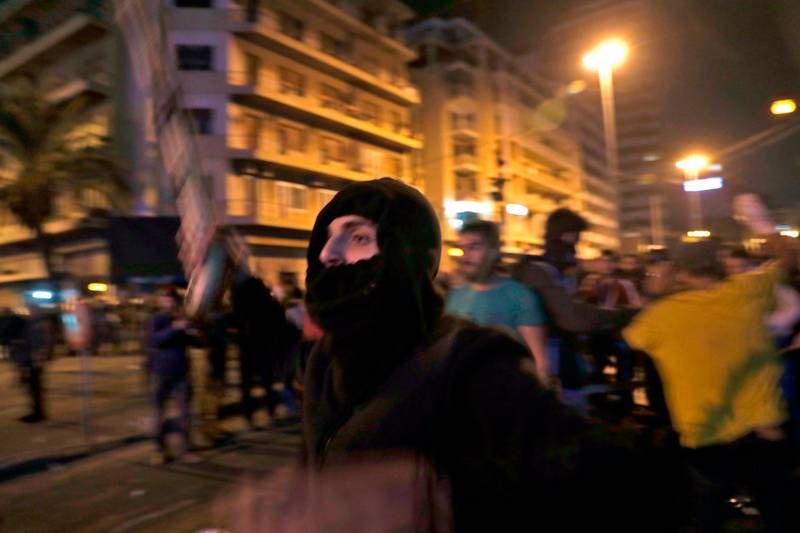 A Lebanese anti-government demonstrator waves a stick while confronting supporters of the Shiite groups Hezbollah and Amal in the capital Beirut.  AFP