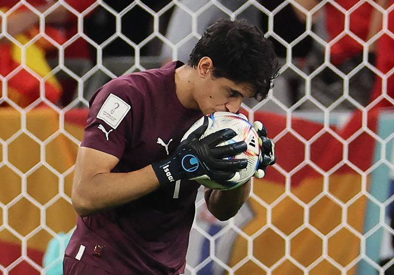 Morocco goalkeeper Yassine Bounou kisses the ball during the penalty shoot-out. AFP