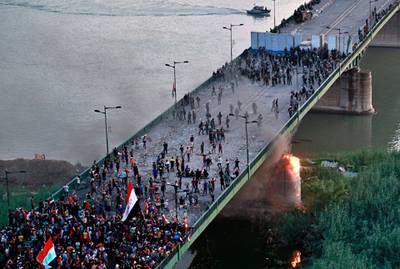 Security forces fire tear gas and close the bridge leading to the Green Zone during a demonstration in Baghdad, Iraq. AP Photo