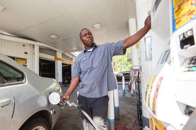 Shell station employee J.W. West fills up a customers tank with gasoline in Mobile, Alabama, USA, 20 April 2020. EPA