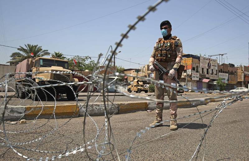 A member of the Iraqi security forces stands guard at a checkpoint in Baghdad's eastern Sadr City suburb.  AFP