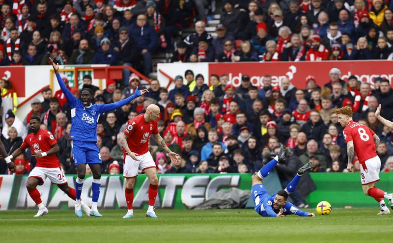 Nottingham Forest's Jonjo Shelvey brings down Everton's Dwight McNeil to give away a penalty. Reuters