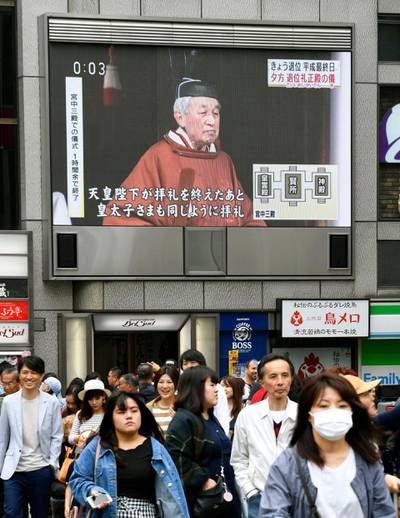 A huge screen shows Japan's Emperor Akihito leaving after a ritual to report his abdication to the throne.  AP