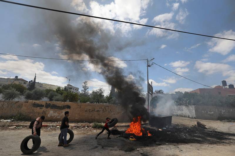Palestinian children burn tyres in Jenin.