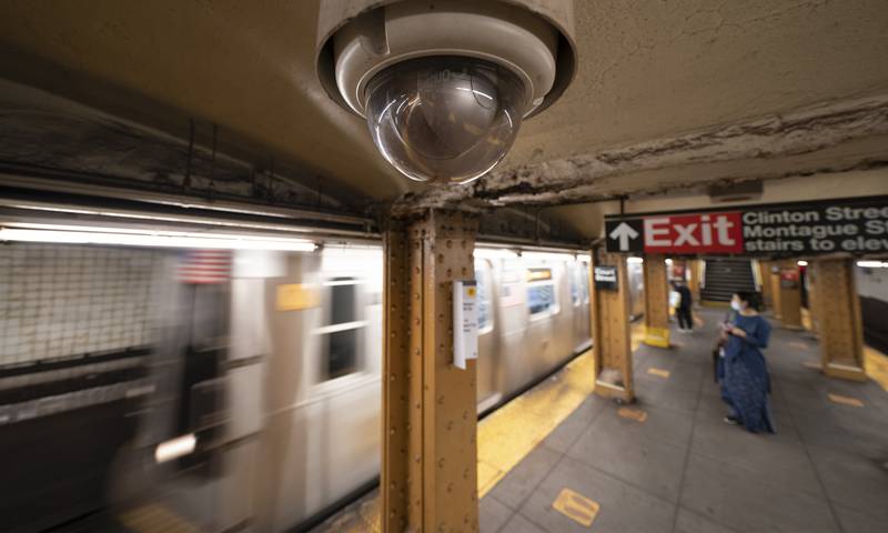 A video surveillance camera hangs from the ceiling above a subway platform in the Brooklyn borough of New York. AP