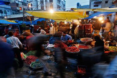 Vendors sell vegetables at a wholesale vegetable market in the old quarters of Delhi. A central bank panel has recommended the Reserve Bank of India focus on managing inflation as its main policy objective. Ahmad Masood / Reuters