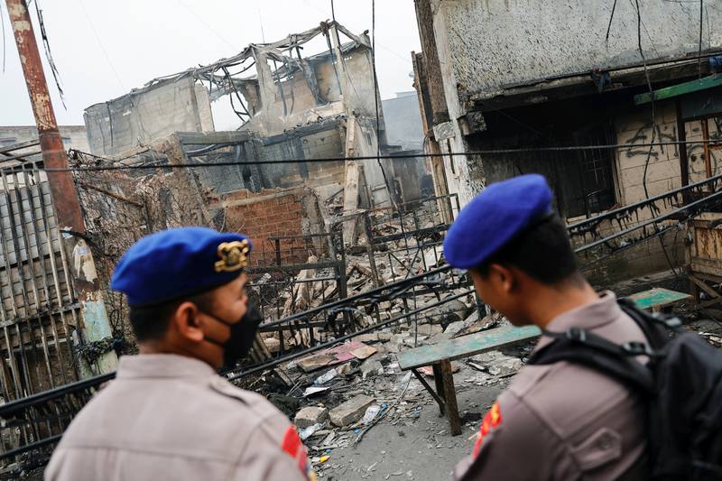 Police stand guard at the scene of a deadly fire at a fuel storage station in Jakarta, Indonesia. Reuters