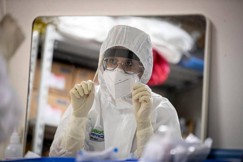 A member of staff wearing personal protective equipment  prepares to work in the Intensive Care Unit  for the novel coronavirus in the San Filippo Neri hospital in Rome, Italy.  EPA