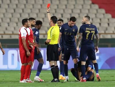Milad Sarlak of Persepolis is shown a red card by referee Ilgiz Tantashev. Reuters
