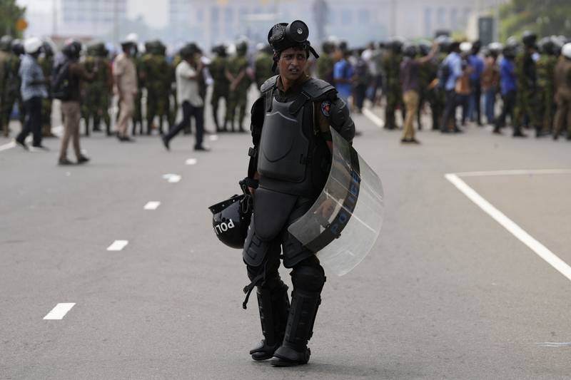 A policeman stands guard in riot gear. AP