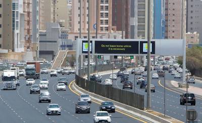 A sign reminds residents to remain vigilant, as they drive along a motorway in Kuwait City.   AFP