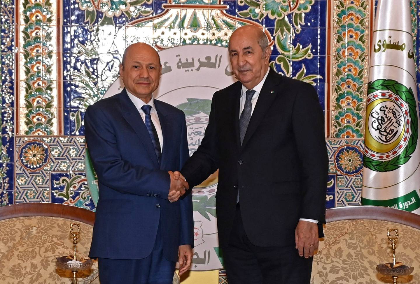 Algerian President Abdelmadjid Tebboune, right, welcomes the head of Yemen's presidential council, Rashad Al Alimi, in Algiers before of the opening of the Arab summit on November 1. AFP  