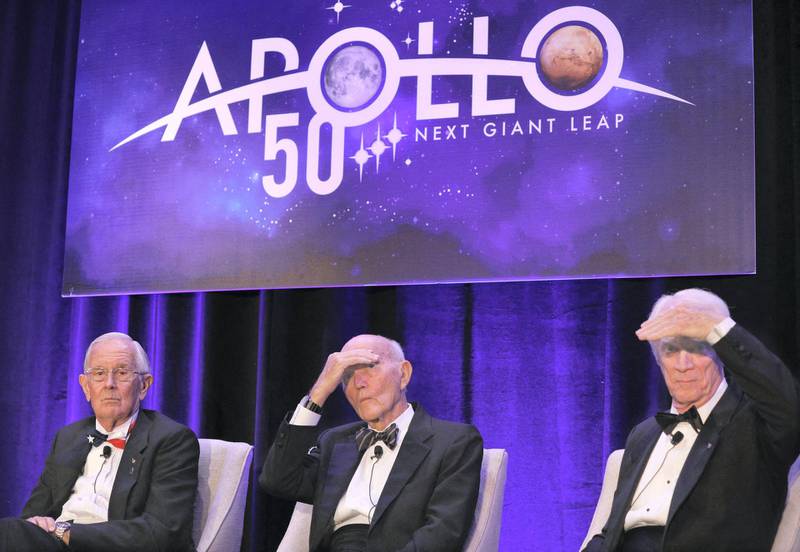 Apollo 11 astronaut Michael Collins (C) and Apollo 9 astronaut Rusty Schweikart (R) shade their eyes, while Apollo 16 astronaut Charlie Duke looks on, while taking a question from a reporter during the 'Legends of Apollo' media in Cocoa Beach, Florida on July 16, 2019, as NASA celebrates the 50th Anniversary of the landing on the Moon. (Photo by Gregg Newton / AFP)