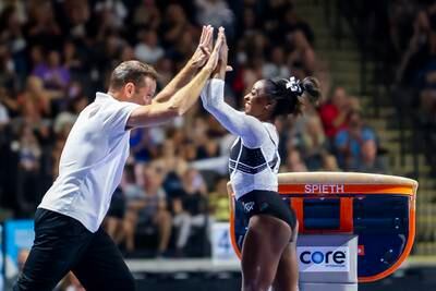 Simone Biles with coach Laurent Landi. Biles returned to competition after a two-year break after the Tokyo Olympics. EPA