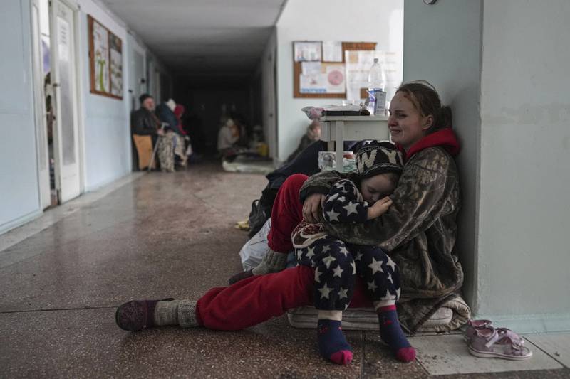 Anastasia Erashova cries as she hugs her child in a corridor of a hospital in Mariupol. AP Photo