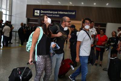 Passengers wearing masks, following the coronavirus outbreak in China, arrive at the Tom Jobim International Airport in Rio de Janeiro, Brazil. Reuters