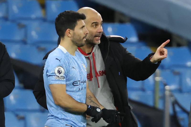 Manchester City's Spanish manager Pep Guardiola (R) briefs Manchester City's Argentinian striker Sergio Aguero during the English Premier League football match between Manchester City and Southampton at the Etihad Stadium in Manchester, north west England on March 10, 2021. (Photo by Clive Brunskill / POOL / AFP) / RESTRICTED TO EDITORIAL USE. No use with unauthorized audio, video, data, fixture lists, club/league logos or 'live' services. Online in-match use limited to 120 images. An additional 40 images may be used in extra time. No video emulation. Social media in-match use limited to 120 images. An additional 40 images may be used in extra time. No use in betting publications, games or single club/league/player publications. / 