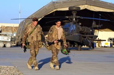 epa03549738 A picture dated 01 November 2012 shows Britain's Prince Harry (L) or just plain Captain Wales as he is known in the British Army, walks to his Helicopter with his fellow pilot at the British controlled flight-line in Camp Bastion, southern Afghanistan, where he served as an Apache Helicopter Pilot/Gunner with 662 Sqd Army Air Corps, from September 2012 for four months until January 2013. Prince Harry ended his five-month deployment in Afghanistan on 21 January 2013 with an admission during a BBC interview that he shot at Taliban insurgents as a co-pilot gunner in an Apache attack helicopter. He remarked: 'Take a life to save a life'.  EPA/JOHN STILLWELL / PA WIRE / POOL UK AND IRELAND OUT *** Local Caption ***  03549738.jpg