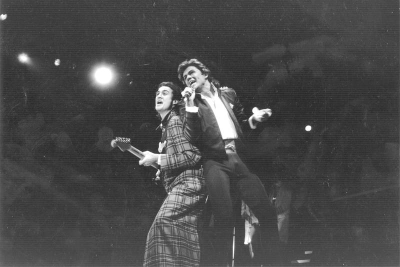 George Michael and Andrew Ridgeley of pop group Wham! during a live performance.  Original Publication: People Disc - HL0194   (Photo by Express Newspapers/Getty Images)