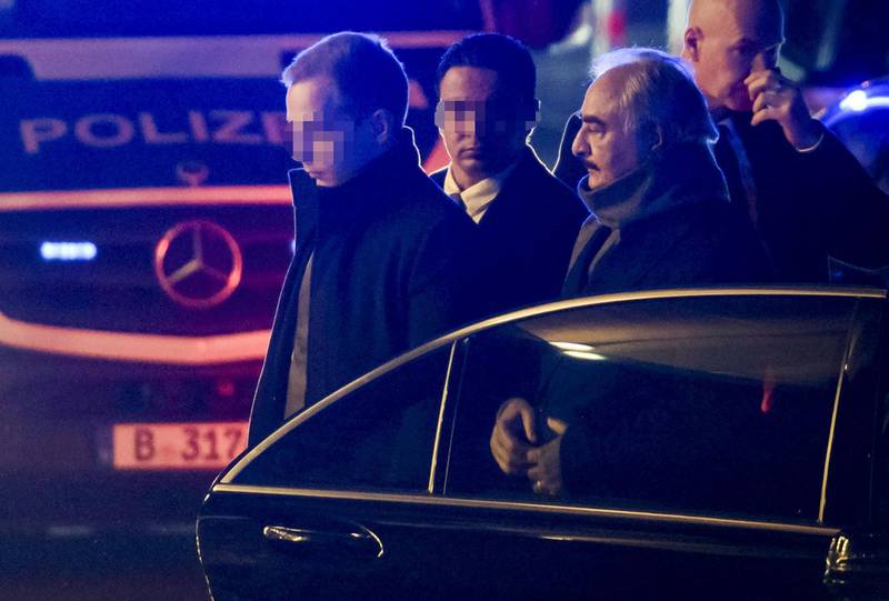 Field Marshal Khalifa Haftar is surrounded by security personnel as he gets out of his car upon his arrival at his hotel in Berlin on the eve of a peace conference on Libya to be held at the Chancellery.  AFP