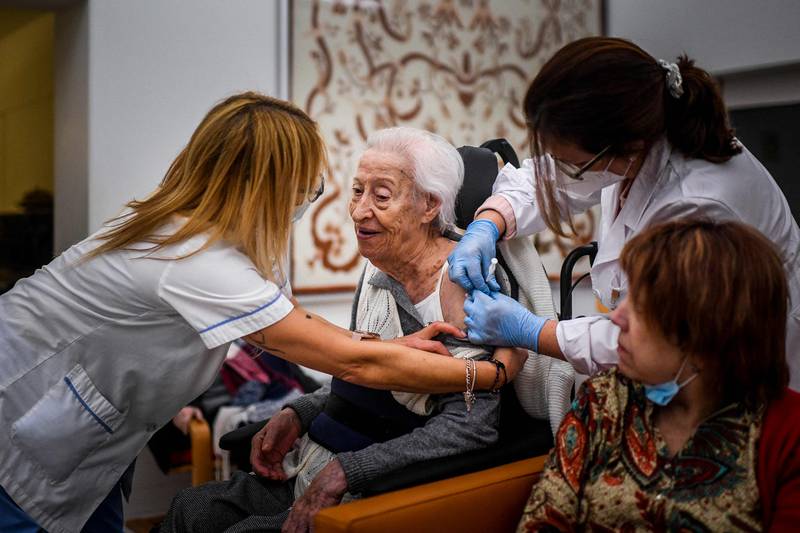 A woman receives a dose of Covid-19 vaccine at a nursing home in Carcavelos, Portugal. AFP
