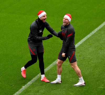 KIRKBY, ENGLAND - DECEMBER 23: (THE SUN OUT, THE SUN ON SUNDAY OUT) James Milner and Jordan Henderson captain of Liverpool wearing Santa hats before a training session at AXA Training Centre on December 23, 2020 in Kirkby, England. (Photo by Andrew Powell/Liverpool FC via Getty Images)
