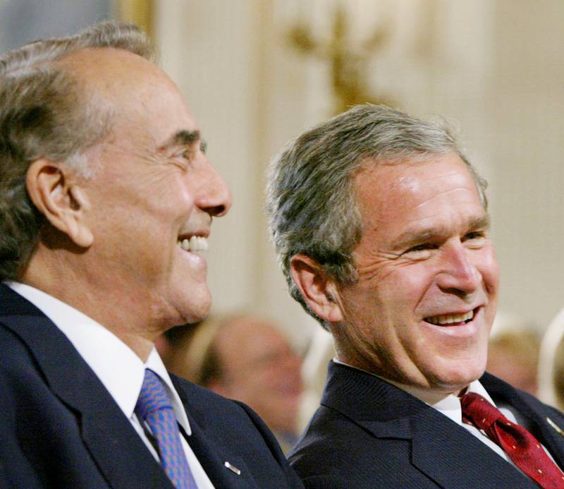 President George W Bush with Dole during a ceremony honouring the USA Freedom Corps, in the East Room of the White House, in July 2002. Reuters