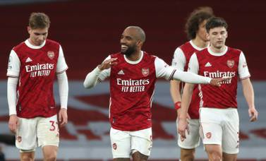 Arsenal's Alexandre Lacazette, centre, celebrates after scoring his side's second goal during the English Premier League soccer match between Arsenal and Tottenham Hotspur at the Emirates stadium in London, England, Sunday, March 14, 2021. (Nick Potts/Pool via AP)