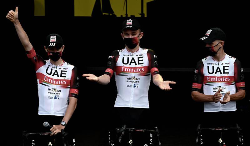 Tadej Pogacar, centre, and UAE Team Emirates teammates attend the team's presentation two days ahead of the 108th edition of the Tour de France. AFP