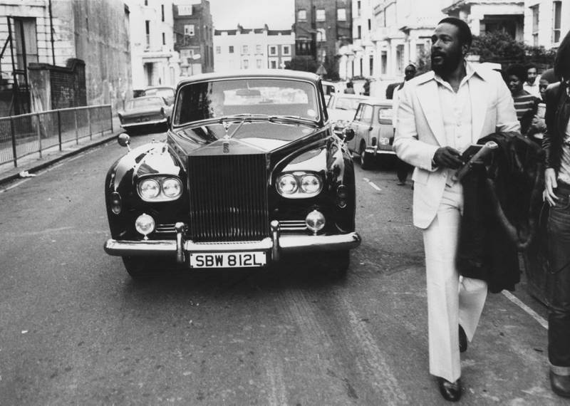 American singer Marvin Gaye walking ahead of his Rolls Royce in Notting Hill, London, in 1976.