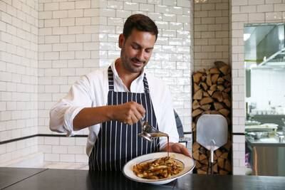DUBAI , UNITED ARAB EMIRATES – June 23 , 2016 : Joey Ghazal , Executive Chef preparing the poutine dish at the Maine restaurant at the Doubletree by Hilton hotel in JBR in Dubai.  ( Pawan Singh / The National ) For Arts & Life. Story by Ann Marie McQueen. ID no : 95338 *** Local Caption ***  PS2306- POUTINE02.jpg