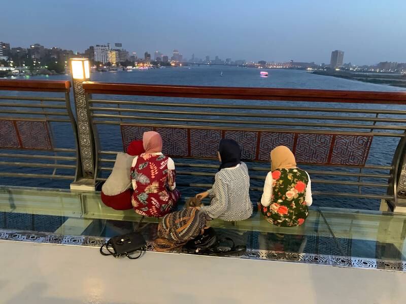 Young Egyptian women sitting on a bridge on the outskirts of Cairo. Hamza Hendawi / The National
