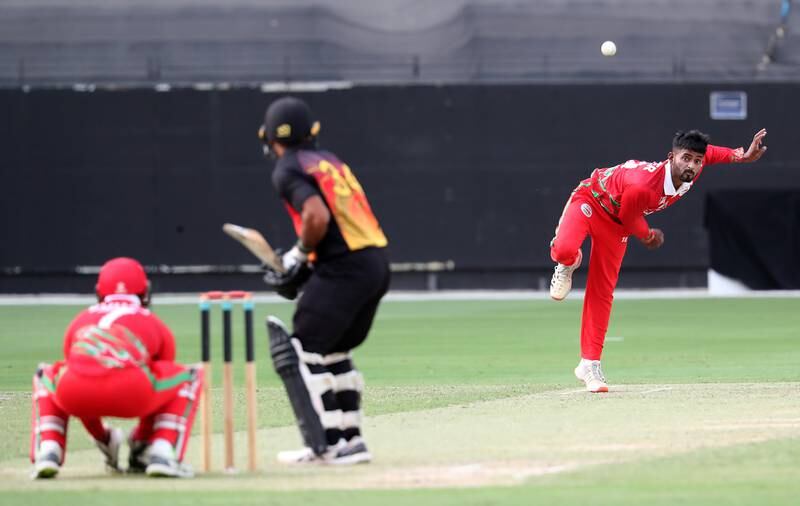 Nestor Dhamba of Oman bowls against Papua New Guinea.
